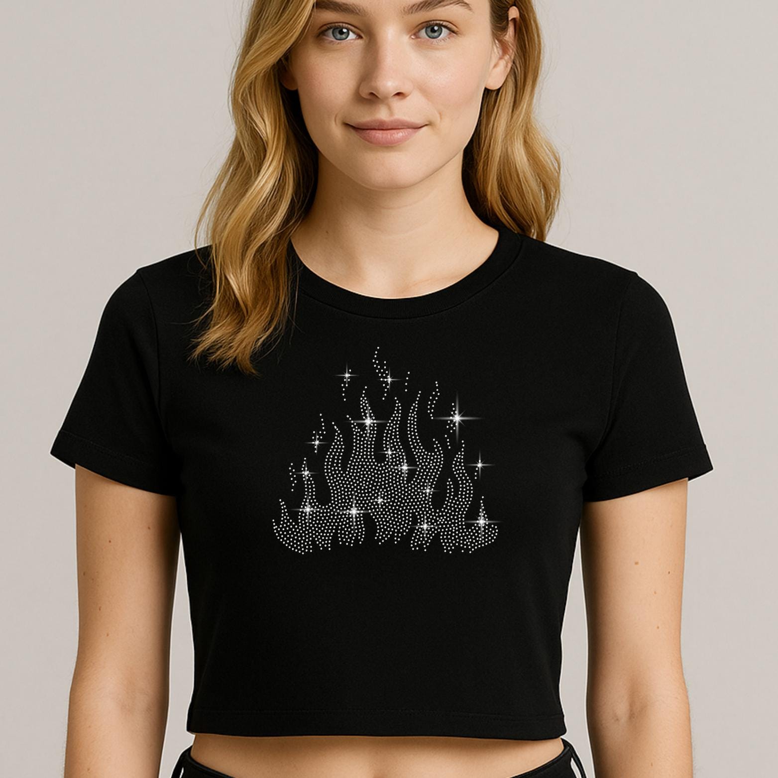 Flame rhinestone design shown on a black crop top
